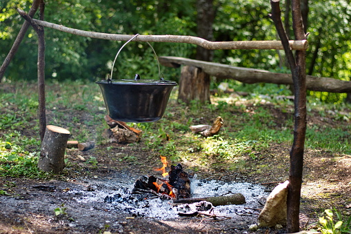 Preparing food on campfire in nature