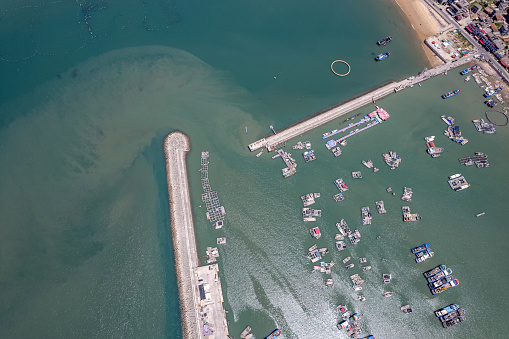 Aerial view of the fishing village port dam on a sunny day