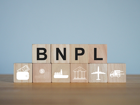 BNPL text buy now pay later on wooden blocks Online shopping installment options.