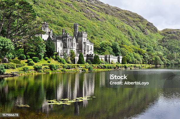 View From Water Of Kylemore Abbey Near Trees In Ireland Stock Photo - Download Image Now