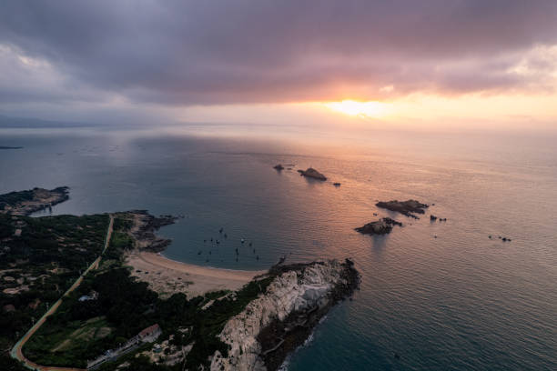 istock Island and reefs at sunrise, unpredictable clouds 1579867663