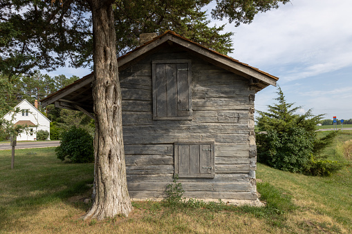 Cokato Township, Minnesota, USA - July 25, 2023: Landscape view of a 19th century log cabin built by Finnish immigrants in 1865, and located at the site of one of Minnesota’s first Finnish immigrant settlements.