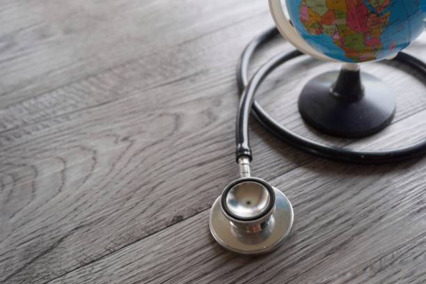 istock Selective focus image of stethoscope and world globe with copy space. 1579868562