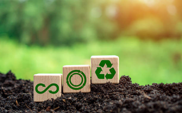 istock Concepts of waste reduction, pollution, reuse, efficient use of resources. Environmental protection sign by recycling on circular wooden board on nature background. 1579871403