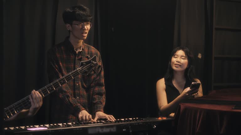 Young Asian Multiracial group live band rehearsal at backstage