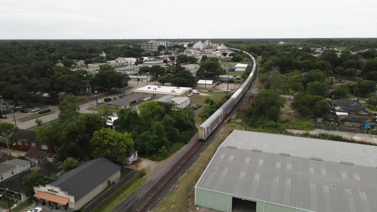 Aerial Following Train Traveling Through Small Town in Texas, USA