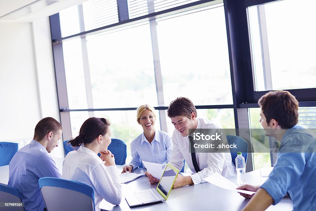 Business team laughing in a meeting at the office Group of happy young  business people in a meeting at office Adult Stock Photo