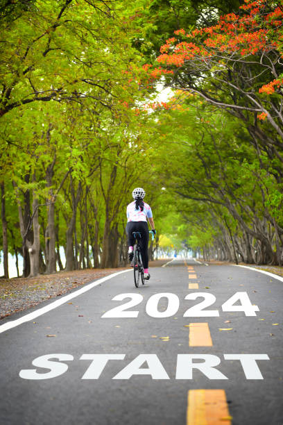 Start new year 2024 on road with white arrow