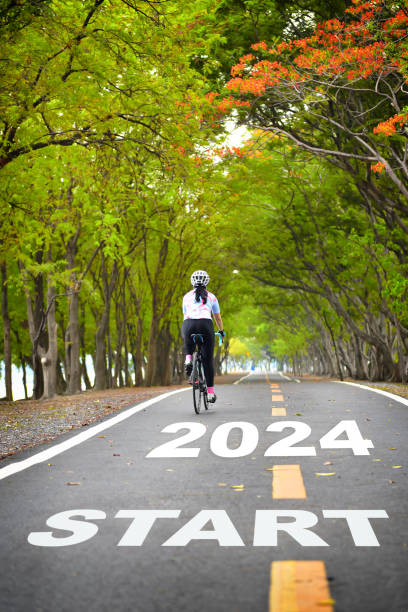 Start new year 2024 on road with white arrow stock photo
