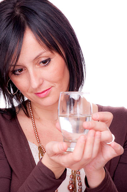istock Half full or empty glass of water 157992499