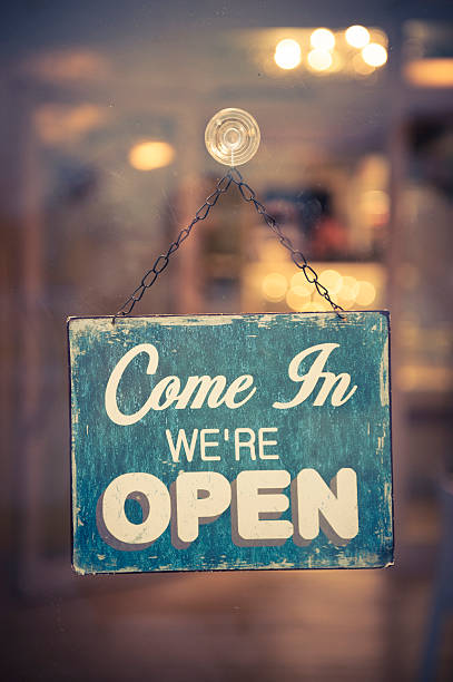 Business Open Sign in window inviting people inside stock photo