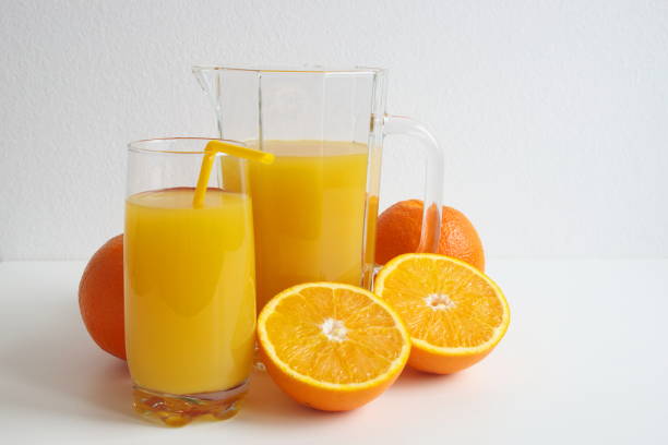 Orange juice and slice of oranges on white background