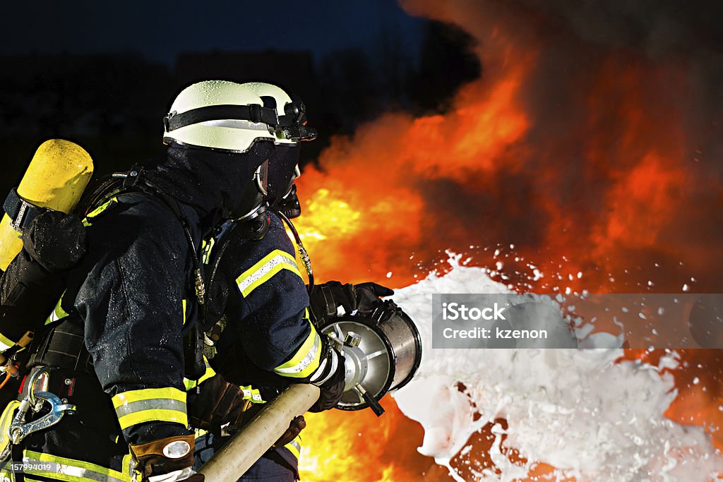 Firefighter - Firemen extinguishing a large blaze Firefighter Stock Photo