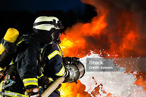 Firefighter Firemen Extinguishing A Large Blaze Stock Photo - Download Image Now - Firefighter, Soap Sud, Extinguishing