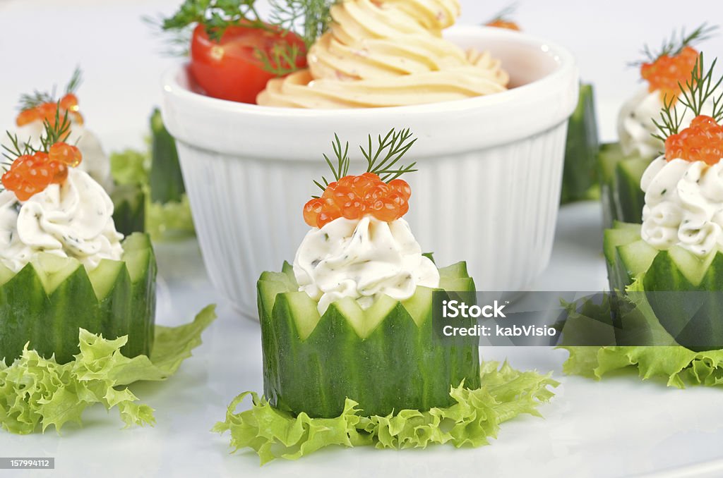 Cream cheese with caviar Fresh cream cheese with herbs and caviar on cucumber Appetizer Stock Photo