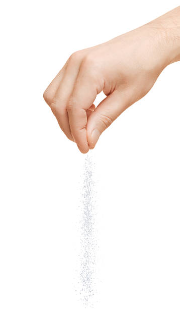 Hand adding salt Hand adding salt on a white background human finger stock pictures, royalty-free photos & images