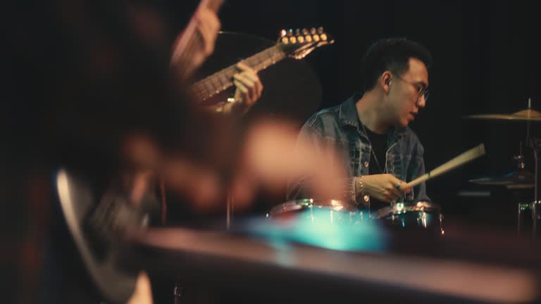 Asian Chinese Drummer jamming session with Multiracial group live band performance on stage