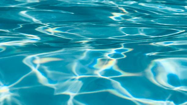 istock Abstract blue water of swimming pool refracting sunlight 1579964348