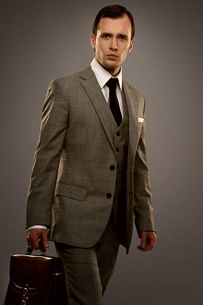 istock Businessman with a briefcase isolated on grey 157996772