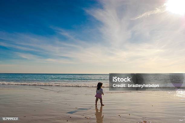 Baby Girl Walks Along A Beautiful Beach Stock Photo - Download Image Now - 12-17 Months, 12-23 Months, Adventure