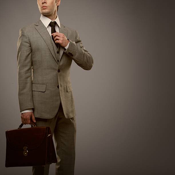 istock Businessman with a briefcase isolated on grey 158001078