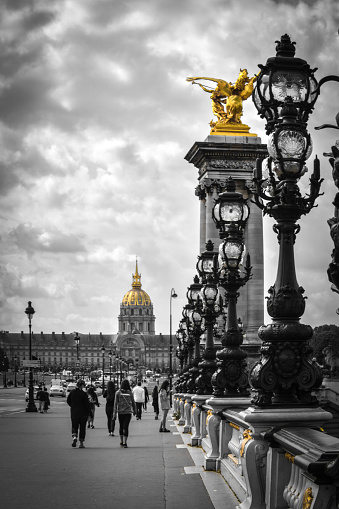 The Pont Alexandre III is a deck arch bridge that spans the Seine in Paris. It connects the Champs-Élysées quarter with those of the Invalides and Eiffel Tower.