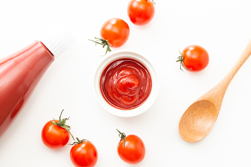Tomato ketchup on white background.\n(bird's-eye view)