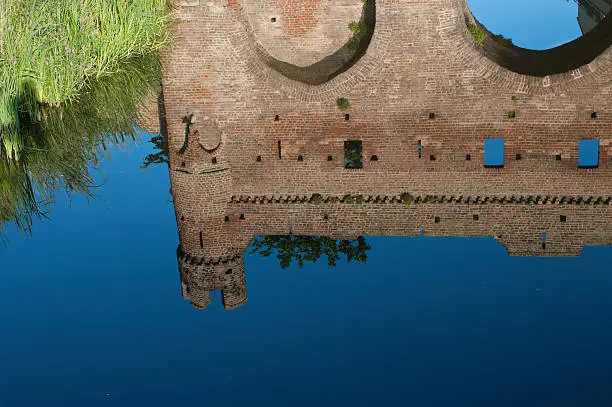 reflection in canal of the medieval defense wall of Zutphen, Netherlands