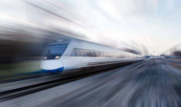 istock High speed train runs on rail tracks - The train is going too fast as a result the air pressure is causing too much heat at the front 1580048659