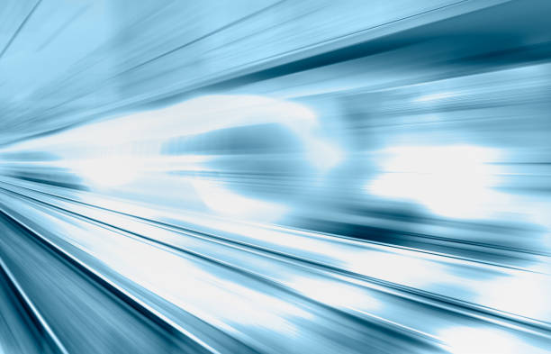 Blue high speed train runs on rail tracks - The train is going too fast as a result the air pressure is causing too much heat at the front