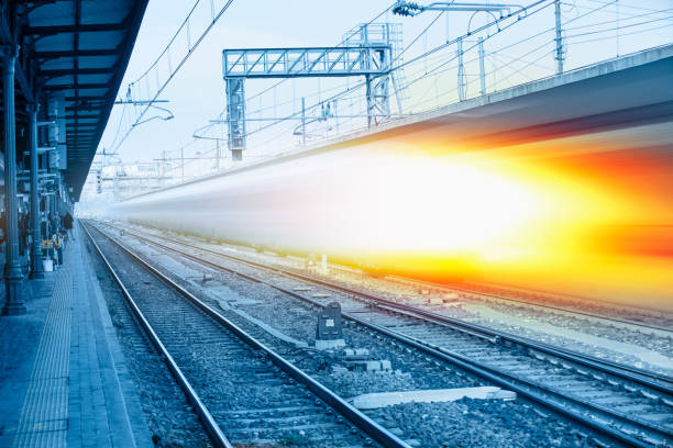 istock Blue high speed train runs on rail tracks - The train is going too fast as a result the air pressure is causing too much heat at the front 1580058558