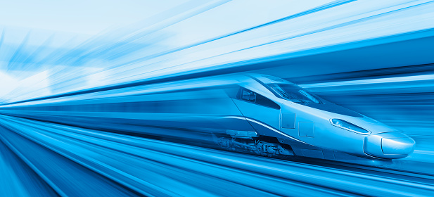 Blue high speed train runs on rail tracks - The train is going too fast as a result the air pressure is causing too much heat at the front