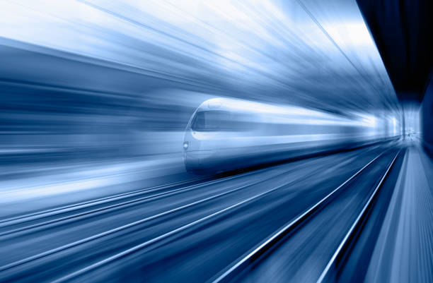 istock Blue high speed train runs on rail tracks - The train is going too fast as a result the air pressure is causing too much heat at the front 1580064322
