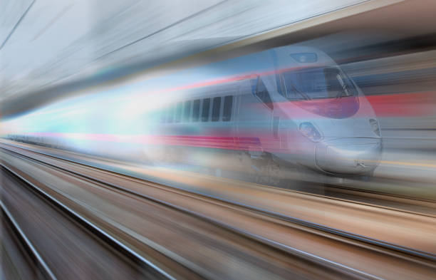 istock Blue high speed train runs on rail tracks - The train is going too fast as a result the air pressure is causing too much heat at the front 1580065892