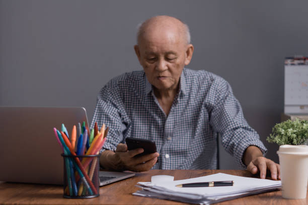 istock Asian senior businessman using mobile phone for work and communication 1580071115