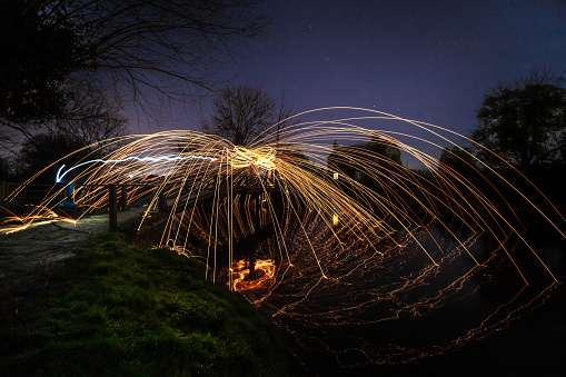 Light painting steel wool spinning near Guildford River Way footbridge Surrey England Europe