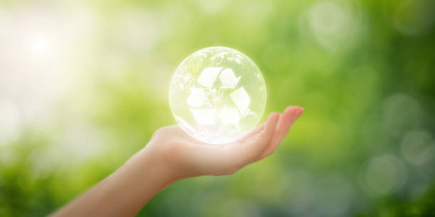 istock Hand holding earth with recycle logo inside on blurred natural background, eco-friendly concept for promoting recycling and environmental sustainability, sustainable world environment 1580161150