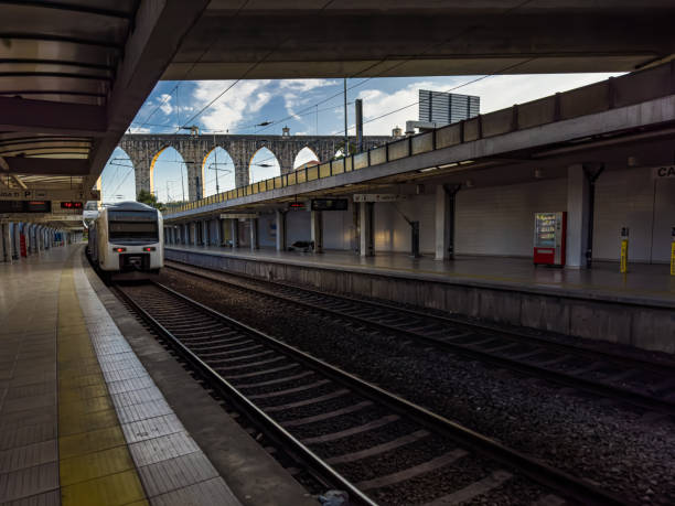 istock Image next to a train station platform with a passing train, in Lisbon, Portugal 1580210151