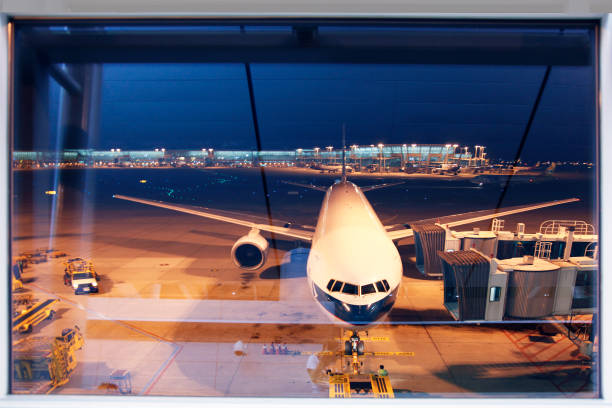 istock Ground glass window of airport terminal at night 1580249621