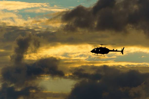 istock the helicopter is flying through a cloudy sky at dusk, 1580307175