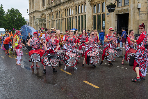 Bath, England, United Kingdom - 8 July 2023: Dancers and musicians dressed in ornate costumes parade through the streets of Bath in the annual carnival.
