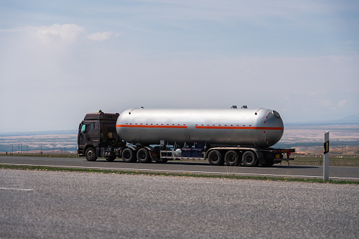 Asphalt road and tanker truck, transportation concept
