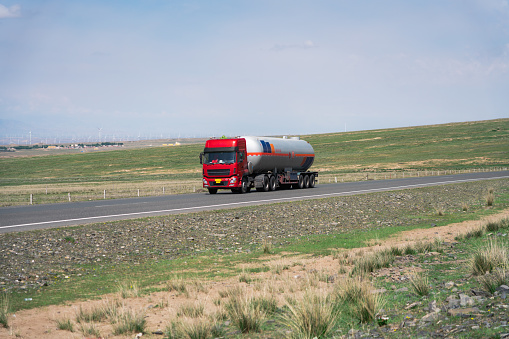 Asphalt road and tanker truck, transportation concept