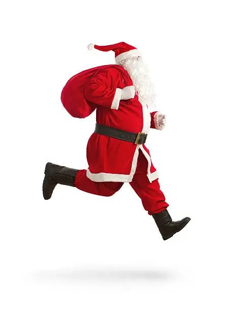 Santa Claus on the run to delivery christmas gifts isolated on white background