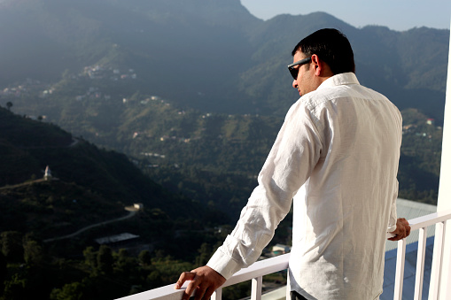 Man taking a break in nature and looking at the distant landscape.