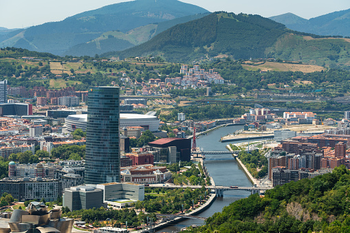 Panoramic view of Bilbao city. Perspective from above of the city. In front the old town and the river Nervion, in background the mountains that surrounding the city. Foggy day Mountains in background