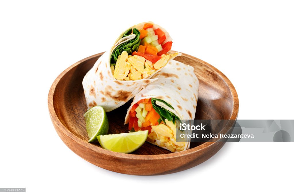 breakfast egg burrito with fresh vegetables Homemade breakfast egg burrito with fresh vegetables and different sauces for healthy vegetarian breakfast. Wrap Sandwich Stock Photo