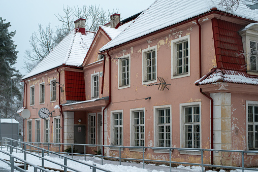 Kiisa, Estonia - January 22 2023: Old historical building of Kiisa train station on a cloudy winter day.