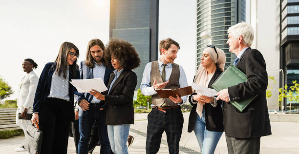 istock Business people discussing about fin tech project after work - Multiracial colleagues doing financial strategies outside of the office - Teamwork and startup concept - Main focus on center man face 1580354534