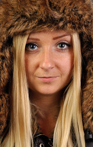 istock Young, pretty blond woman in fur cap. 158036274